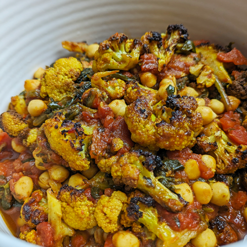 Roasted cauliflower curry in a white serving dish