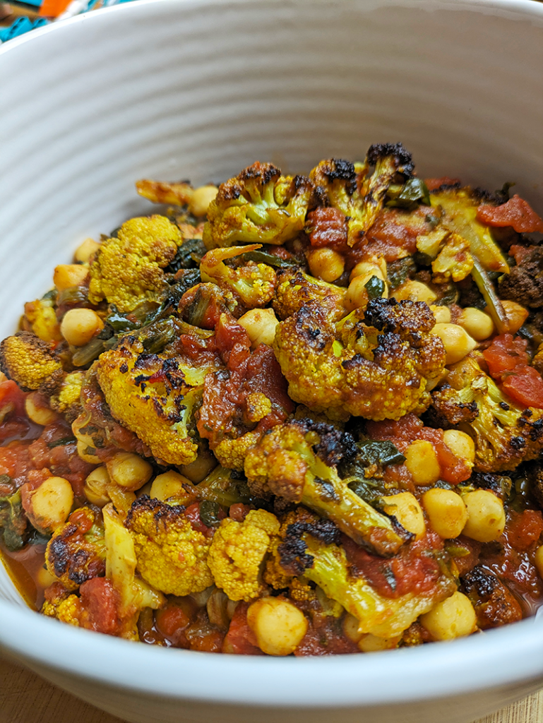 Roasted Cauliflower and Chickpea Curry in a white serving dish