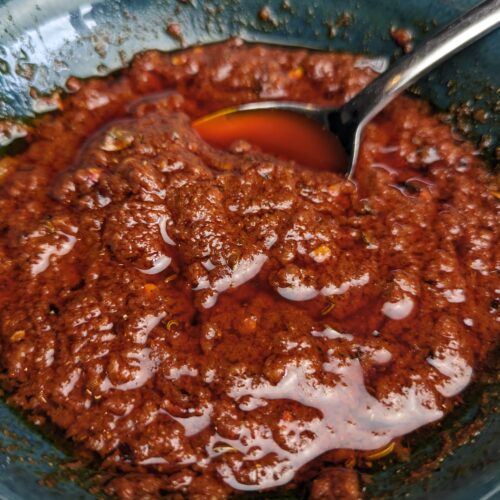 An alternative Harissa Paste in a bowl with a spoon