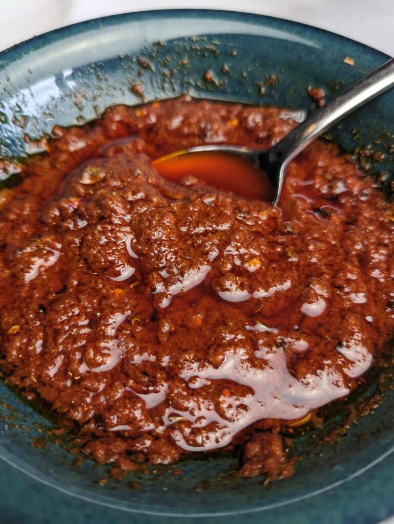 An alternative Harissa Paste in a bowl with a spoon