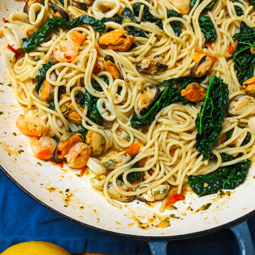 Seafood Spaghetti with Cavolo Nero in a Cast Iron enamel shallow dish.