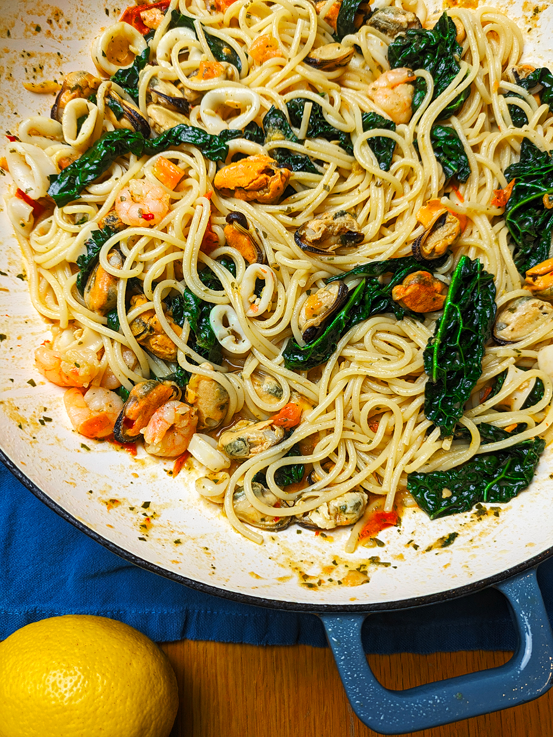 Seafood Spaghetti with Cavolo Nero in a Cast Iron enamel shallow dish.