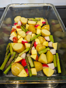 New potatoes, radish, aspargus and apple ready for roasting.